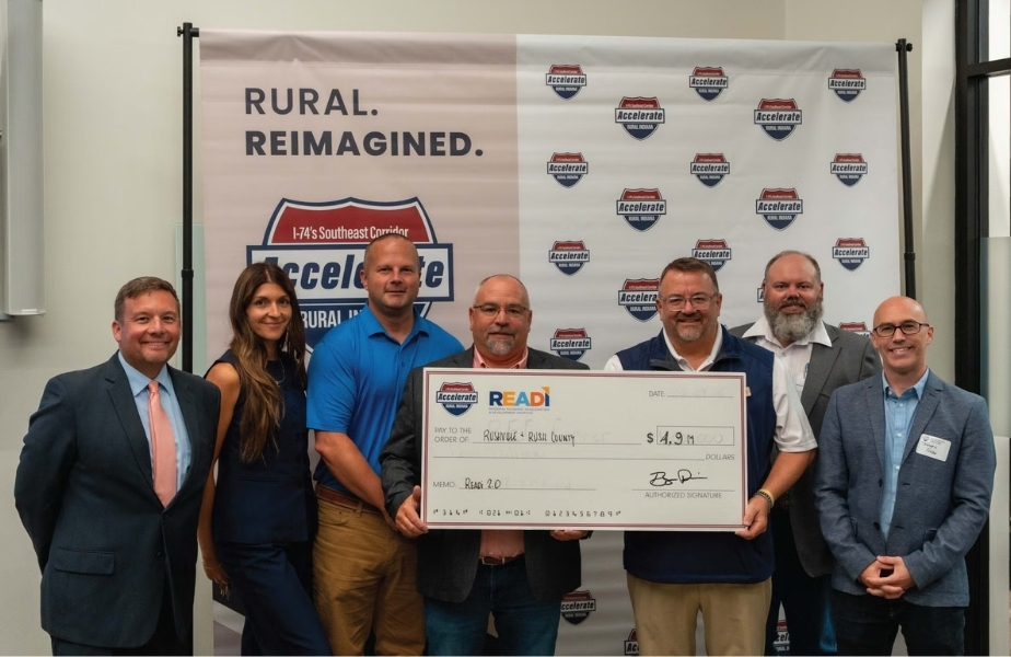 Rushville and Rush County representatives display a ceremonial $4.9 million READI 2.0 funding check at the Accelerate Rural Indiana event.